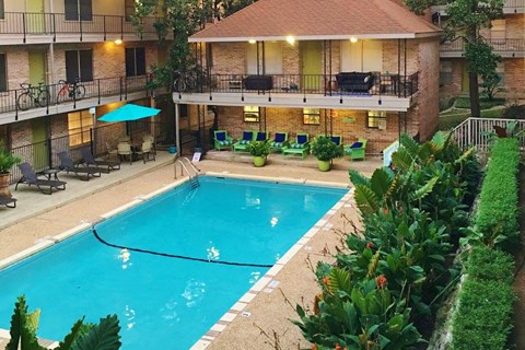 a swimming pool in front of a house with a pool